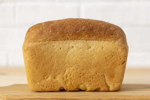 A loaf of wheat bread on the table. Stock-Fotos