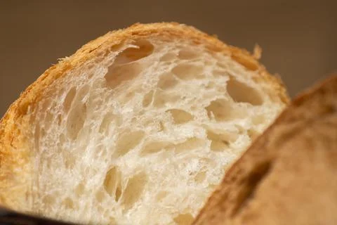 Loaf of white bread with brown bread in the foreground. Stock Photos
