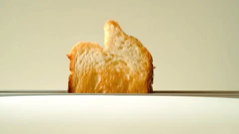 A loaf of white bread jumping out of the toaster for breakfast in the morning Stock Footage 292937185
