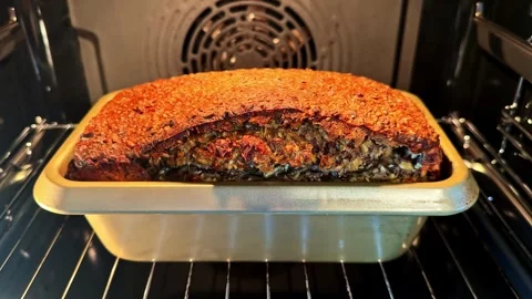 Loaf of Whole Grain Seed Bread Baking Inside a Hot Convection Oven. Stock Footage 341541897