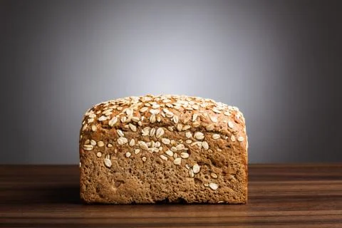 Loaf of wholemeal bread on table Stock Photos