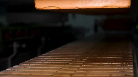 Loafs of bread in a bakery on an automated conveyor belt Stock Footage 196609250