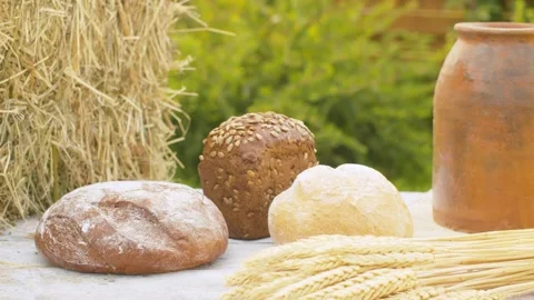 Loafs of bread, wheat ears and clay pot Stock Footage 141602172