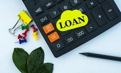 LOAN - word on yellow note sheet on white background with calculator, pencil, Stock Photos