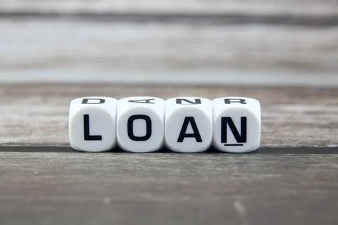 Loan wording  or text on white dice with black wooden background.Copy space.. Stock Photos