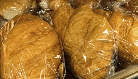 Loaves of bread wrapped in plastic Stock Photos