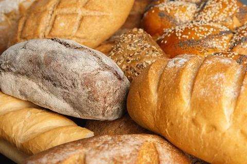 Loaves of different breads as background, closeup Foto stock
