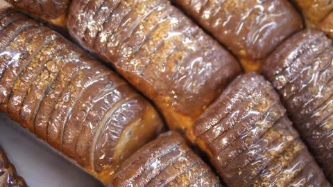 Loaves of sliced bread or a loaf standing in a row. Finished sliced product. Stock-Footage 313323715