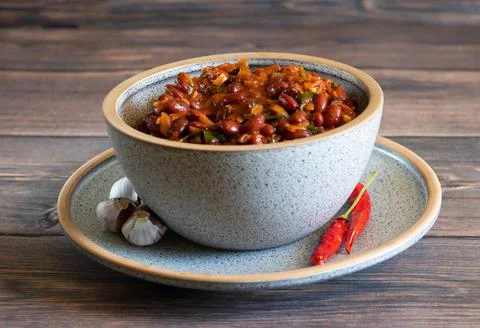 Lobio made of stewed red beans in a bowl on a wooden background Stock Photos