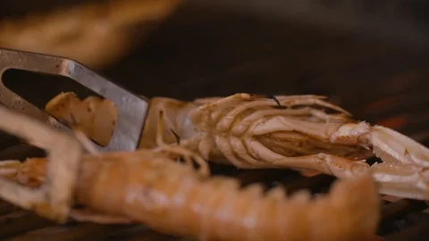 Lobster picked up from the grill with tongs Stock Footage 85812853
