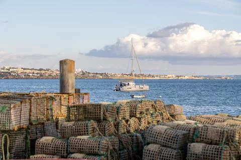 Lobster trap stacks beside Atlantic coastline town view Foto stock