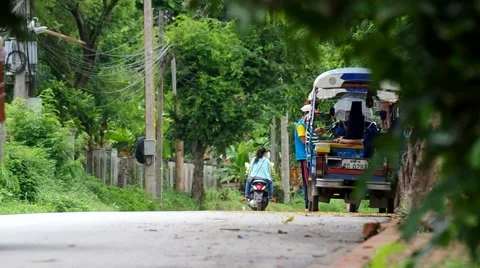 Local 3 wheels motorcycle running on the road in Loas Stock Footage 53164302