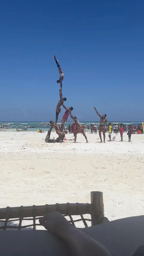 Local acrobats perform human pyramid on Matemwe beach in Zanzibar Vídeo Stock 344039705
