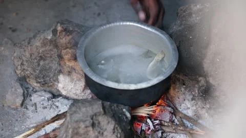 Local African Man Cooking Fish in a Pot, January 21, 2025, Tumbatu Island, Video stock 336896366