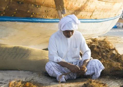 Local Arab man making ropes in a traditional way Stock Photos
