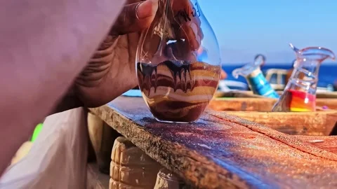 Local artisan creating colored sand art bottle in Sharm El Sheikh Stock Footage 339042531