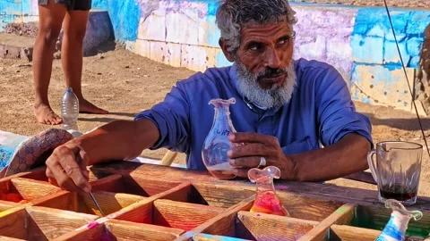 Local artisan creating colored sand art bottle in Sharm El Sheikh Stock Footage 339042567