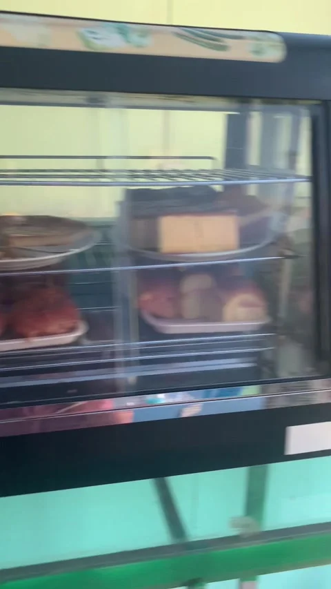 Local bakery display case with pastries and shop interior Maldives Vidéo 344602889
