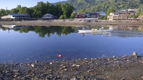 Local boat passing through polluted river 動画素材 105096295