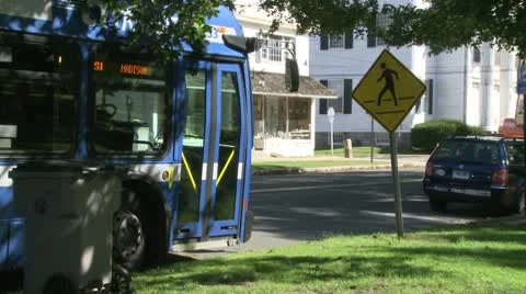 Local bus pulling away from bus stop Stock Footage 10685250