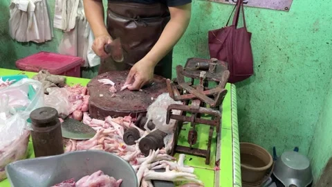 A local butcher is seen expertly preparing raw chicken. 스톡 동영상 319405076