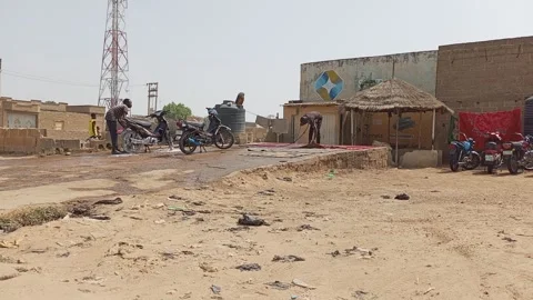 Local Car Wash Point Workers Washing Carpet and Motorcycles Kano Nigeria Stockbeeldmateriaal 323297801
