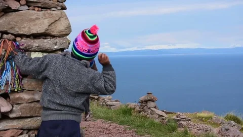 A local child throws a stone against a tourist Video stock 79589150