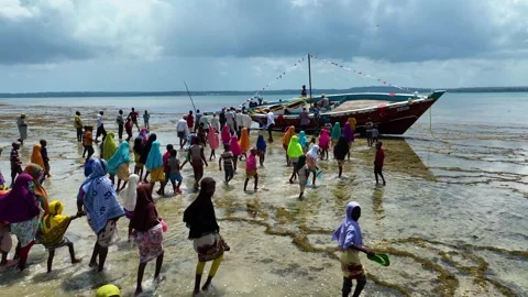 Local Community Walking Toward a Stranded Boat at Low Tide, January 21, 2025, Video stock 336895963