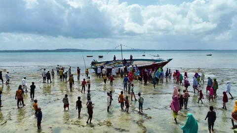Local Community Walking Toward a Stranded Boat at Low Tide, January 21, 2025, Video stock 336896042
