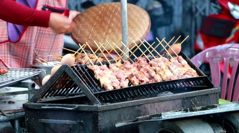Local Cook local Thai styled pork babeque at famous Kad Kong Ta walking street Stock Footage 65036141