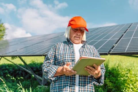 Local engineer using digital tablet app to look at energy performance of solar Stock Photos