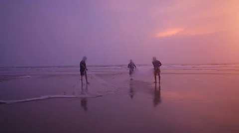 Local fishermen pull net from the ocean Stock Footage 61378838