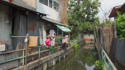 Local House Hanging Clothes Next to Canel - Bangkok, Thailand Stock Footage 147617860