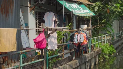 Local House Hanging Clothes Next to Canel - Close Up - Bangkok, Thailand Stock Footage 147617870