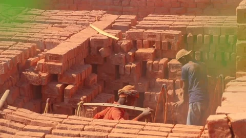 Local Indian workers stacking and collecting dusty red bricks for Stock Footage 235266675
