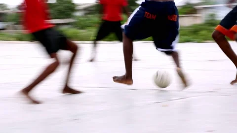 Local kids playing soccer barefoot in Po... | Stock Video | Pond5