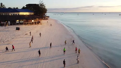Local kids playing sunset football Nungwi Beach, Zanzibar, Tanzania Stock Footage