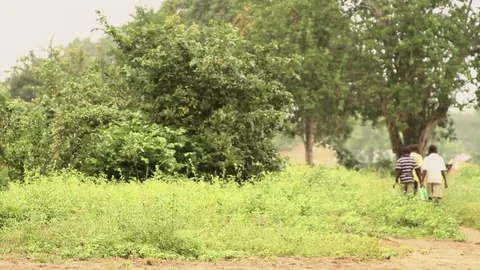 Local kids walking on forest path during rainfall 動画素材 73547912