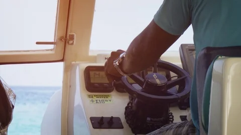 Local man piloting small passenger boat off Rihiveli Beach Resort in Maldives Stock Footage 87447502