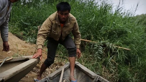 Local man preparing boat in Laos Stock Footage 104121290