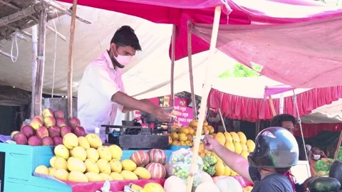 Local market reopen after ease in lock down restrictions, Man sell fruit, 4k Stock Footage 130787622