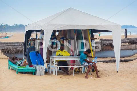 Local Men Renting Surf Boards At Weligama Beach