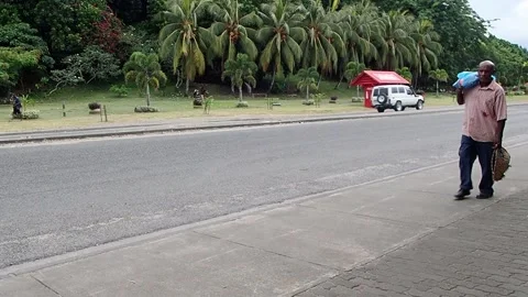 Local Men Walking Along Main Street in Kokopo Town, Papua New Guinea Stock Footage 136159055
