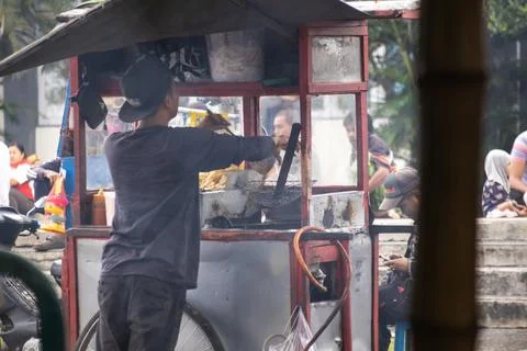 Local merchant serving customers from a mobile food cart in Lombok, Indones.. Stock Photos