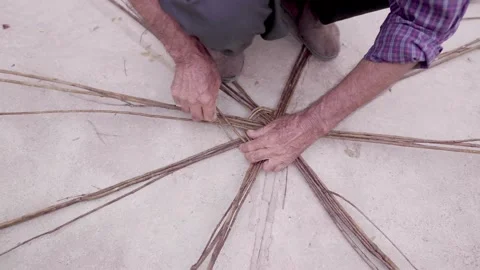 A local middle eastern  man weaving a eco recyclable basket using Stock Footage 237913137