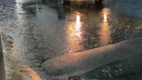 Local mini van passing the flood area on the street Stock Footage 255963830