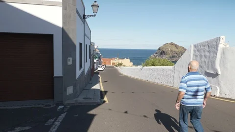 Local Old Man Walking In The Shadow Garachico Tenerife Spain see view Stock Footage 104546269