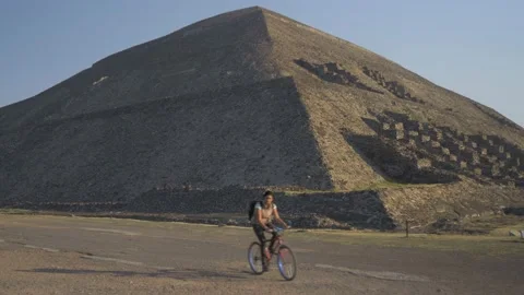 Local Passes By On Bicycle At Pyramid Of The Sun At Teotihuacan, Mexico City Stock Footage 154628128