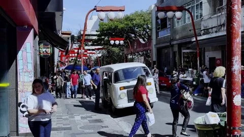 Local People and Visitors cross Busy Retail Street in Liberdade District 스톡 동영상 345009673