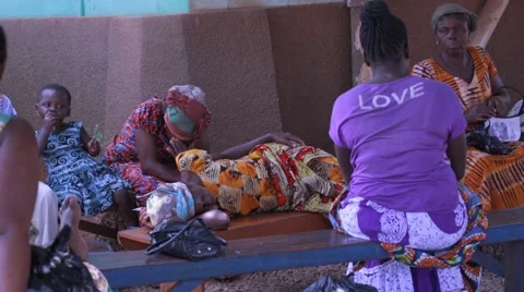 Local people sitting on bench in Ghana Stock Footage 62388024